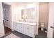 Dual vanity in a main bathroom featuring a marble countertop, white cabinets, and modern lighting fixtures at 1566 Lindsey Creek Dr, Mount Pleasant, SC 29466