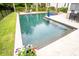 A luxurious pool area with dining, mature palms, flowers, and lounge chairs provides an outdoor oasis at 1566 Lindsey Creek Dr, Mount Pleasant, SC 29466