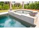 View of a large swimming pool with attached spa, fire bowls and patio with palms at 1566 Lindsey Creek Dr, Mount Pleasant, SC 29466