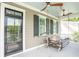 Inviting covered porch with a porch swing, ceiling fans, and a telescope at 1566 Lindsey Creek Dr, Mount Pleasant, SC 29466