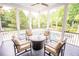 Outdoor seating area with comfortable arm chairs and a screened-in porch overlooking the pool at 1566 Lindsey Creek Dr, Mount Pleasant, SC 29466