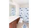 Bright bathroom featuring a fun, shark-themed shower curtain and a single sink vanity with updated fixtures at 1749 Towne St, Johns Island, SC 29455