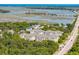Aerial view shows condos near a marsh with the ocean in the distance at 1984 Folly Rd # A310, Charleston, SC 29412