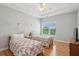 Bright bedroom with two beds, wood floors, a ceiling fan, and a large window with natural light at 1984 Folly Rd # A310, Charleston, SC 29412