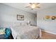 Bedroom features wood floors, ceiling fan, beach-themed décor, and a bright window view at 1984 Folly Rd # A310, Charleston, SC 29412