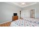 Bright bedroom features two beds, wood floors, a dresser, and a nearby closet and ensuite bathroom at 1984 Folly Rd # A310, Charleston, SC 29412