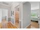 Bright hallway featuring wood floors and doorways leading to the bedrooms and bathroom at 1984 Folly Rd # A310, Charleston, SC 29412