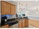 Open kitchen and living area featuring granite countertops and hardwood floors at 1984 Folly Rd # A310, Charleston, SC 29412