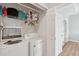 Bright laundry room with washer, dryer, and shelving for storage at 1984 Folly Rd # A310, Charleston, SC 29412