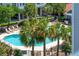 Community pool view with palm trees and plenty of lounge chairs at 1984 Folly Rd # A310, Charleston, SC 29412
