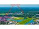 Aerial view of Cane Bay Schools, community ponds and landscaping, with forest backdrop at 201 Bigleaf Ct, Summerville, SC 29486