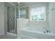 Bright bathroom featuring a soaking tub and a glass-enclosed shower at 201 Bigleaf Ct, Summerville, SC 29486