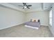 Large bedroom with carpet, featuring a ceiling fan and tray ceiling for a luxurious feel at 201 Bigleaf Ct, Summerville, SC 29486