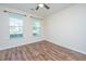 Bright bedroom with hardwood floors and two windows, offering a peaceful retreat at 201 Bigleaf Ct, Summerville, SC 29486
