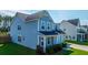 A bright blue two-story home with manicured lawns and colorful shrubbery at 201 Bigleaf Ct, Summerville, SC 29486