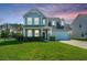 Charming two-story home featuring a well-manicured lawn and an attached two-car garage at 201 Bigleaf Ct, Summerville, SC 29486