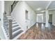 Welcoming foyer with hardwood floors, staircase, and ample natural light from the front door at 201 Bigleaf Ct, Summerville, SC 29486
