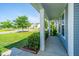 Inviting front porch with classic columns and view of the landscaped neighborhood at 201 Bigleaf Ct, Summerville, SC 29486
