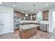 A spacious kitchen featuring wood floors, a large island, granite countertops, and stainless steel appliances at 201 Bigleaf Ct, Summerville, SC 29486