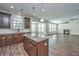 Open-concept kitchen with wood floors, a center island with granite countertops, and a view of the living room at 201 Bigleaf Ct, Summerville, SC 29486