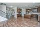 Open-concept kitchen featuring wood floors, a large island, granite countertops, and stainless steel appliances at 201 Bigleaf Ct, Summerville, SC 29486