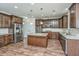 A spacious kitchen featuring wood floors, a large island, granite countertops, and stainless steel appliances at 201 Bigleaf Ct, Summerville, SC 29486