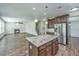 Open-concept kitchen featuring wood floors, a granite island and stainless steel appliances, with living room in view at 201 Bigleaf Ct, Summerville, SC 29486