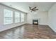 Living room with hardwood floors, fireplace and three large bright windows at 201 Bigleaf Ct, Summerville, SC 29486