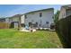 Lush backyard featuring a patio with outdoor seating, string lights, and a well-maintained lawn at 2021 Asher Loop, Summerville, SC 29485