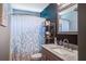 Stylish bathroom with a vanity, sink, modern fixtures, and shower with leaf-patterned curtain at 2021 Asher Loop, Summerville, SC 29485