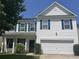 Charming two-story home featuring white siding, blue shutters, and an attached two-car garage at 2021 Asher Loop, Summerville, SC 29485