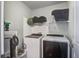 Bright laundry room with white washer and dryer, wire shelving, and storage space at 2021 Asher Loop, Summerville, SC 29485