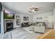 Bright living room features a cozy fireplace, ceiling fan, and comfortable sofas and a plush rug at 2021 Asher Loop, Summerville, SC 29485