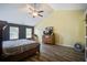 Main bedroom features hardwood floors, vaulted ceilings, and a large window with natural light at 2021 Asher Loop, Summerville, SC 29485