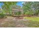 Backyard with mature trees and a deck, offering a private and tranquil outdoor space at 2028 Prospect Hill Dr, Mount Pleasant, SC 29464