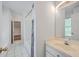 Bright bathroom featuring a shower with tile, vanity, and a view of trees at 2028 Prospect Hill Dr, Mount Pleasant, SC 29464