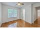 Bedroom with wood floors, ceiling fan, and a large window overlooking trees at 2028 Prospect Hill Dr, Mount Pleasant, SC 29464
