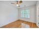 Bright bedroom featuring hardwood floors, ceiling fan, and a large window at 2028 Prospect Hill Dr, Mount Pleasant, SC 29464