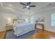 Bright bedroom features a ceiling fan, tray ceiling, and two windows at 2028 Prospect Hill Dr, Mount Pleasant, SC 29464