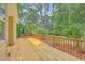 A spacious wooden deck with brown railing overlooks the lush green yard at 2028 Prospect Hill Dr, Mount Pleasant, SC 29464