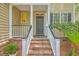 Front porch with brick stairs and classic design welcomes you into the home at 2028 Prospect Hill Dr, Mount Pleasant, SC 29464