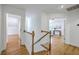 Upstairs hallway with hardwood floors and white railing at 2028 Prospect Hill Dr, Mount Pleasant, SC 29464