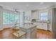 Open kitchen with granite island, white cabinets, stainless steel refrigerator, and breakfast nook at 2028 Prospect Hill Dr, Mount Pleasant, SC 29464