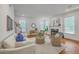 Bright living room featuring hardwood floors, fireplace, and large windows with neutral-toned decor at 2028 Prospect Hill Dr, Mount Pleasant, SC 29464