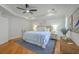 Serene main bedroom offers a tray ceiling, hardwood floors, and a comfortable seating area at 2028 Prospect Hill Dr, Mount Pleasant, SC 29464