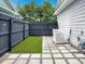 Small fenced backyard with partial grass, pavers, and gravel for easy maintenance and privacy at 2064 Promenade Ct, Mount Pleasant, SC 29466