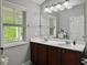 Bathroom with double vanity, large mirror, ample lighting, and a large window with natural light at 2064 Promenade Ct, Mount Pleasant, SC 29466