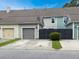 Townhome exterior featuring attached garages, dark fences, and neatly trimmed grass along the driveway at 2064 Promenade Ct, Mount Pleasant, SC 29466