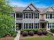 Townhome exterior with a small porch, dark shutters, and a well-maintained green lawn at 2064 Promenade Ct, Mount Pleasant, SC 29466