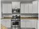 Well-appointed kitchen featuring stainless steel appliances, granite countertops, and white cabinetry at 2064 Promenade Ct, Mount Pleasant, SC 29466